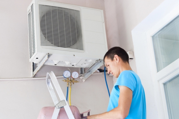 HVAC technician refilling heat pump refrigerant