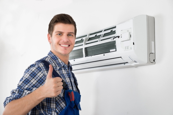 HVAC technician doing a thumbs up after installing ductless HVAC