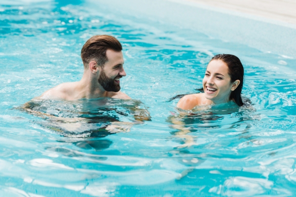 couple enjoying swimming in the pool