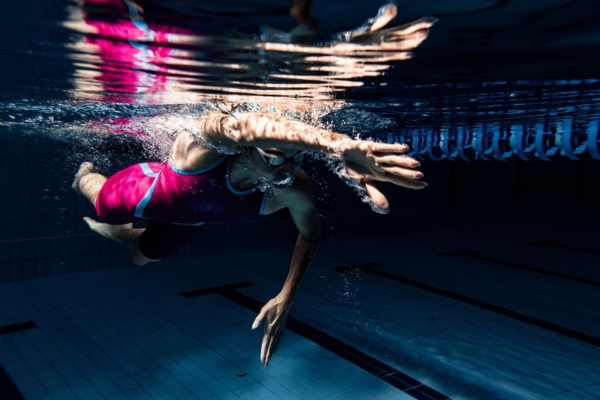 swimmer training at night in the heated pool