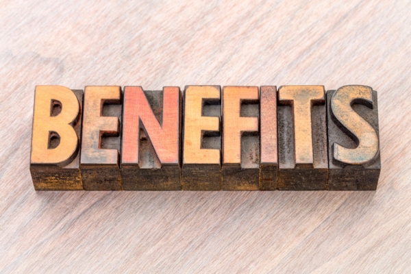 BENEFITS spelled using wooden letterpress depicting automatic oil delivery