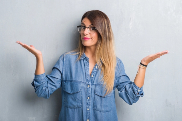 woman shrugging with both her hands on the side depicting comparing will call vs automatic oil delivery