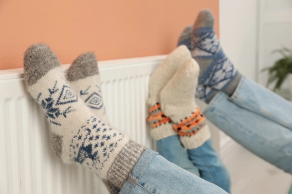feet keeping warm on an oil heat radiator