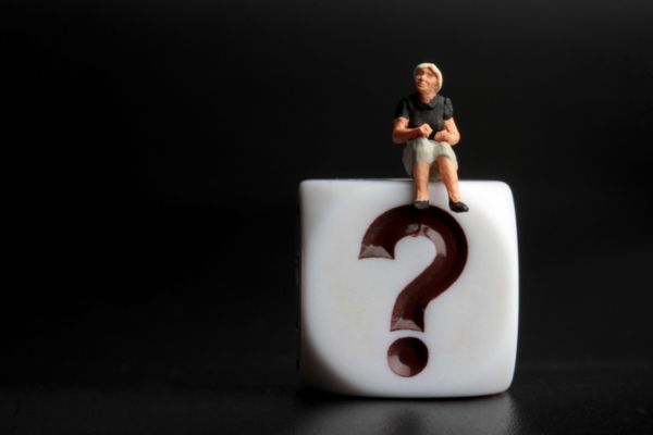 plastic dice with question mark etched on surface and a miniature person person sitting on top depicting Diesel Fuel Regulations FAQs